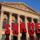 Protesters hold signs outside the Wisconsin Capitol. (Justin Sullivan/Getty Images)
